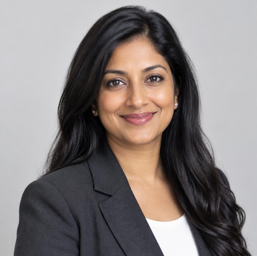 Portrait of a woman with long dark hair wearing a dark blazer